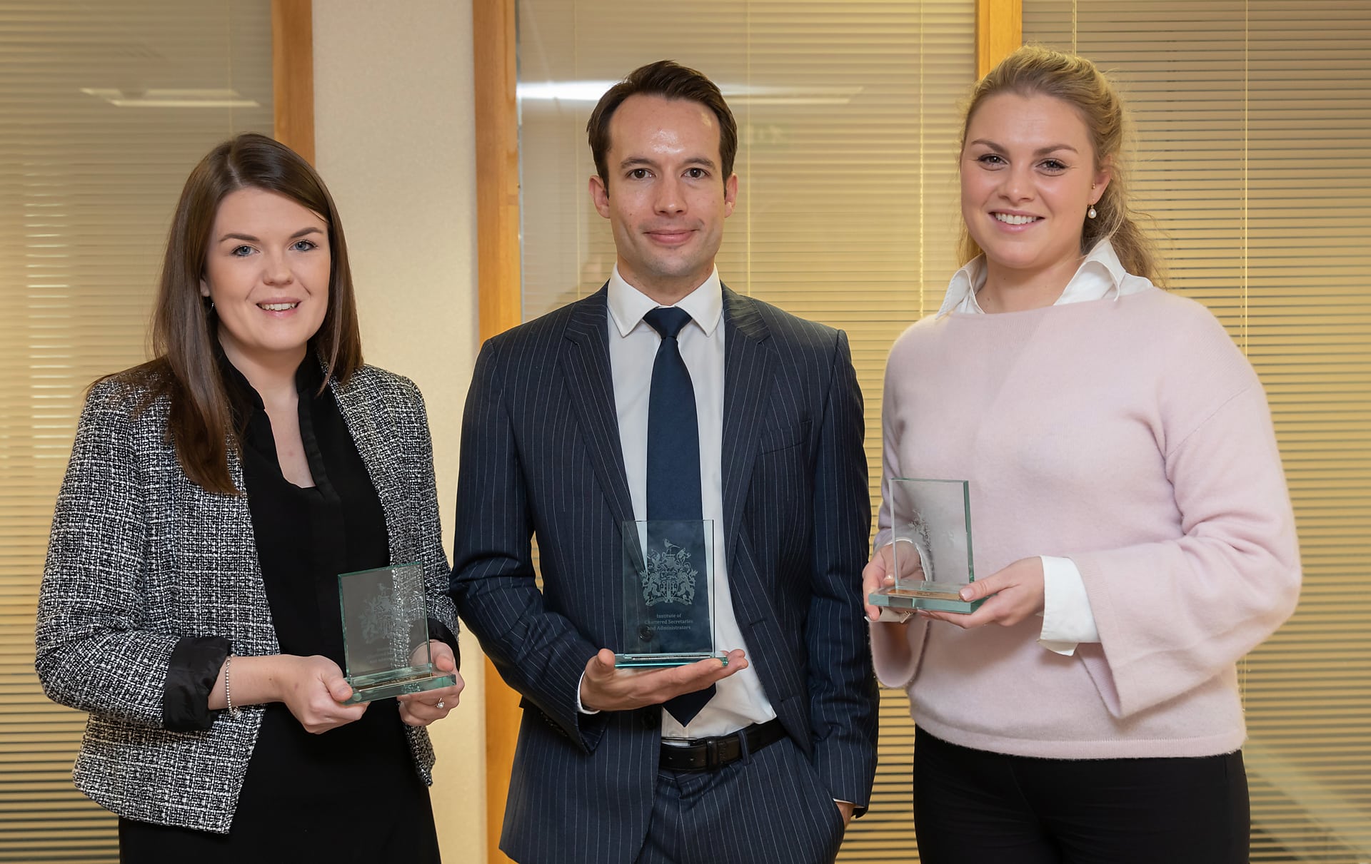 Gemma Woods, Matt Falla and Gwen Norman posing side by side with their ICSA Awards 